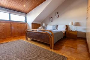 a bedroom with a bed and a window at Atticview Oropos in Néa Palátia