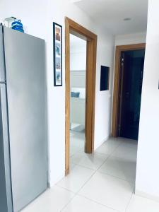 a room with an open door and a refrigerator at Sea & Pool View Apt 1 in Aourir