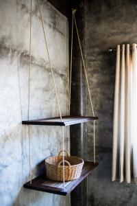 a shelf with two baskets on top of a wall at Sweet Life Guesthouse in Ko Lanta