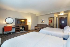a hotel room with two beds and a television at Hampton Inn & Suites Flagstaff - West in Flagstaff +33 photos
