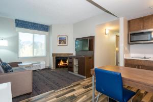 a living room with a table and a fireplace at Hampton Inn & Suites Flagstaff - West in Flagstaff
