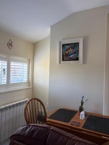 a room with a table and a chair and a picture at The Stable in Stourton in Stourbridge