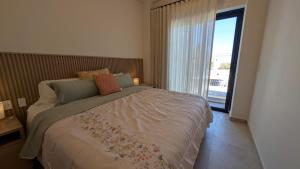 a bedroom with a large bed with a large window at Vista Cortes 2BR 2BA Condo - Walk to the Malecon! in La Paz