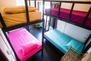 two bunk beds in a room with a chair at Sweet Life Community Guesthouse in Ko Lanta