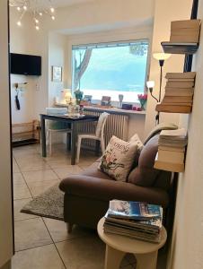 a living room with a couch and a table at Lake Como PORTO VECCHIO - Charming Lakefront Apartment in the Heart of Domaso in Domaso