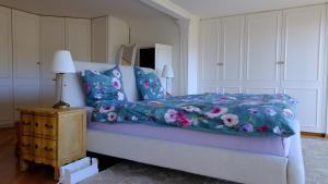 a bedroom with a bed with a blue comforter at Rose Garden Switzerland in Avry devant Pont