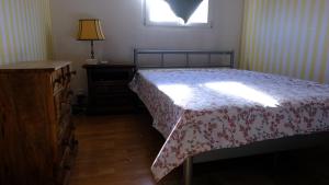 a bedroom with a bed and a dresser and a window at Rose Garden Switzerland in Avry devant Pont