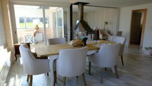 a dining room with a table and white chairs at Rose Garden Switzerland in Avry devant Pont +26 photos