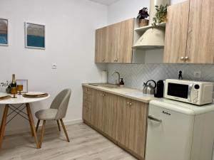 a kitchen with a white refrigerator and a microwave at Danube12 in Šamorín
