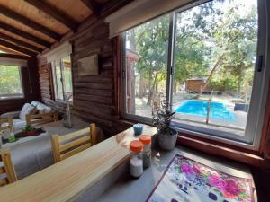 a dining room with a table and a view of a pool at La Ardilla Chueca in Luján