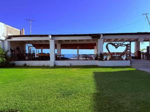 a house with a green lawn in front of it at Hotel Yopez in Acapulco