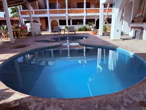 a swimming pool in a resort with blue water at Hotel Yopez in Acapulco