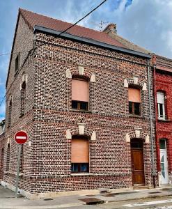 a brick building with a stop sign in front of it at Cozy & Lumineux in Marly