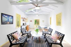 a living room with black chairs and a table at Puerta Azul in Sandy Bay