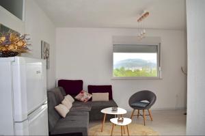 a living room with a couch and a refrigerator at Suncrest in Mostar