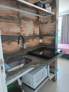 a kitchen with a sink and a counter top at Suíte praia de leste in Pontal do Paraná
