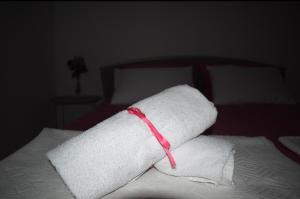 a stack of towels sitting on top of a bed at Suncrest in Mostar