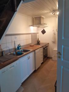 a kitchen with a sink and a counter top at Borgahallen The Wedding Room in Rimbo +21 photos