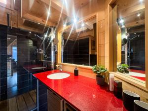 a bathroom with a red counter and a red sink at Chalet Boder - Vue MontBlanc - Cheminée in Finhaut