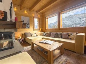 a living room with a couch and a fireplace at Chalet Boder - Vue MontBlanc - Cheminée in Finhaut