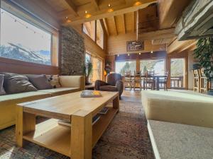 a living room with a couch and a table at Chalet Boder - Vue MontBlanc - Cheminée in Finhaut