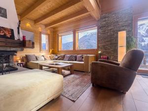 a living room with a couch and a table at Chalet Boder - Vue MontBlanc - Cheminée in Finhaut +37 photos