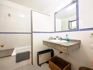 a bathroom with a sink and a mirror at El Pisito Dulce Vista in Tías +25 photos