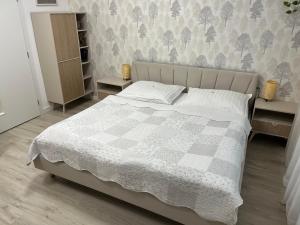 a bedroom with a bed with a checkered blanket at Danube12 in Šamorín