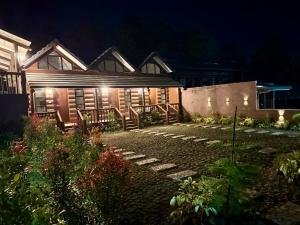 a house at night with lights in the yard at Log Cabin Tagaytay in Tagaytay