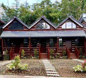 a red and white house with trees in the background at Log Cabin Tagaytay in Tagaytay