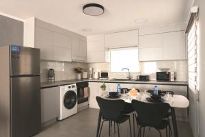 a kitchen with a table and chairs in it at TelMar Kiti Escape House in Kiti