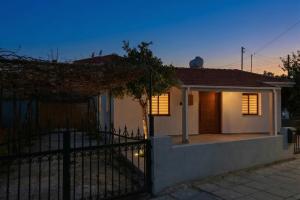 a house with a fence in front of it at TelMar Kiti Escape House in Kiti