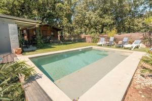 a swimming pool in the backyard of a house at Cabaña Rural El Arbol near Setenil - Ronda con piscina in Ronda
