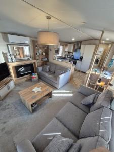a living room with a couch and a table at Whitstable Hemsworth Villa in Seasalter