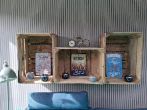 a wall with two wooden shelves with items on them at Vakantiehuis 2 Wheels 2 Relax in Wellen