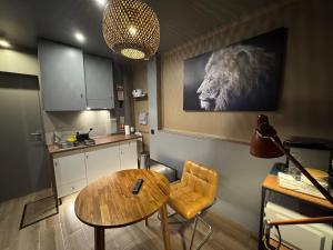 a kitchen with a table and a lion on the wall at Kiosk 550 Apartment - Póvoa de Varzim in Póvoa de Varzim