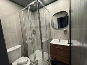 a bathroom with a shower and a toilet and a sink at Kiosk 550 Apartment - Póvoa de Varzim in Póvoa de Varzim