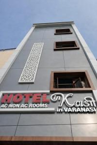 a white building with a sign on the side of it at Hotel In Kashi in Varanasi