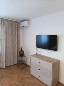 a living room with a flat screen tv on a wall at Casa Mia 2 in Punat