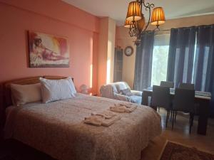 a bedroom with a bed with two towels on it at Sofia's pottery house in Volos