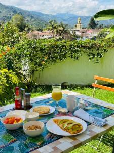 a picnic table with food and a glass of orange juice at Terrazas de Salento in Salento