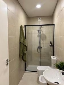 a bathroom with a shower and a toilet and a sink at Azorescape in Lagoa