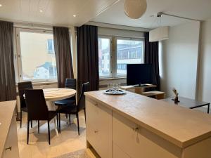 a kitchen and dining room with a table and a table and chairs at Apartment Kopin5 in Kokkola +9 photos