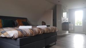 a bedroom with a large bed in a room at Torenzicht in Kapelle