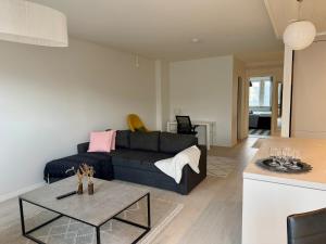 a living room with a couch and a table at Apartment Kopin5 in Kokkola