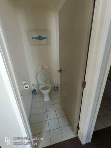 a bathroom with a toilet and a picture on the wall at Opuke Crash Pad Methven - with mountain views. in Methven +17 photos