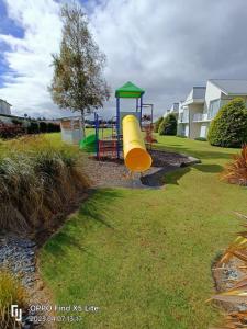 a playground with a slide in a yard at Opuke Crash Pad Methven - with mountain views. in Methven
