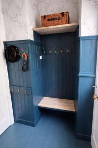 a room with a blue wall with a bench at The Counting House in Alnwick +31 photos