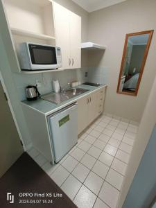 a small kitchen with a sink and a microwave at Opuke Studio Methven in Methven