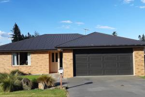 a brick house with a garage at Methven Crash Pad in Methven